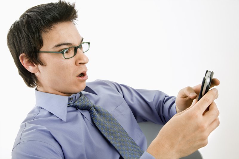 Man surprised at text message.
